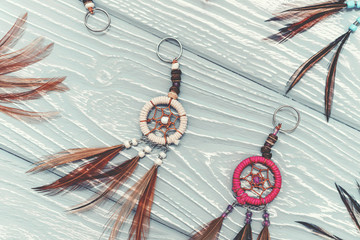 Ethnic dreamcatchers on a wooden background. Dream catchers, indian amulet, feathers, decoration.