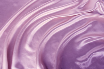 soft folds on delicate pink, lilac shining silk, luxury concept, background for the designer, horizontal, close-up, copy space