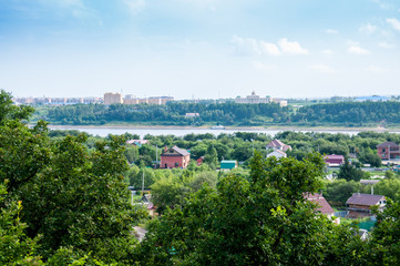 Fototapeta na wymiar Russia, Blagoveshchensk, July 2019: View of the Amur river in the summer, on both banks of the city of Blagoveshchensk and the city of Heihe
