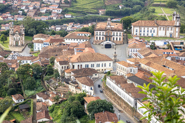Fototapeta na wymiar Central square of colonial mining city centre Ouro Preto in Minas Gerais, Brazil, with facade of the Museum of Inconfidence and Tiradentes monument seen from a high altitude and large distance