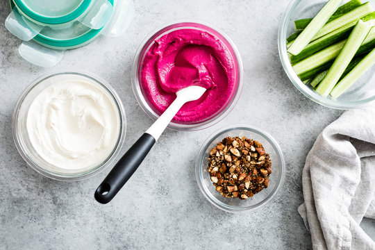 Pink beet cashew hummus swirled with garlic yogurt tahini and sprinkled with roasted almond za&rsquo;atar.