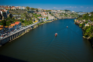 Fototapeta na wymiar Boats sailing on the Douro River in a beautiful early spring day