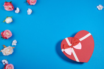 The Background Of Valentine's Day. Gifts, flowers, heart, box in pastel blue colors. The Concept Of Valentine's Day. Flat sunbed, top view, copy space