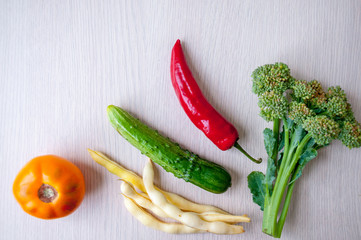 Harvest on the table: red pepper, cucumber, broccoli, asparagus beans and yellow tomato
