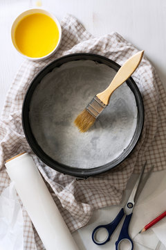 A springform pan brushed with melted butter and lined with paper.