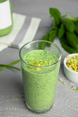 Green buckwheat smoothie on light grey wooden table