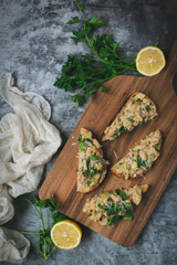 Toast slices with white lemon beans on top, styled dark background