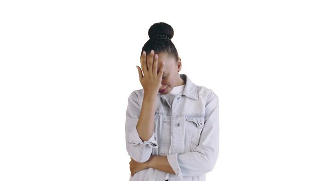 Portrait of upset african american girl perplexedly looking in camera on white background. Face palm expression Jean jacket