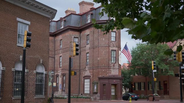 Historical building with American flag sitting at an intersection in downtown Annapolis, MD.