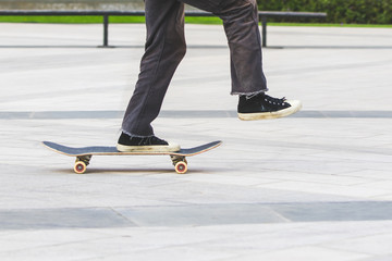 legs in skateboard on road
