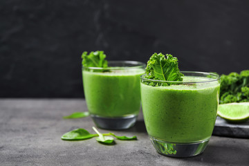 Tasty kale smoothie on grey table, closeup
