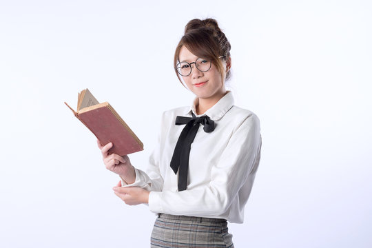 A cute girl student hold an opened book
