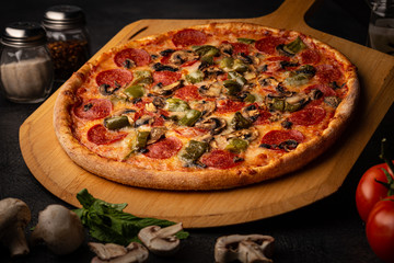 Full delicious pizza displayed on a peel