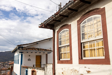 Typical colourful facade of central historical mining city with large window frames in natural shades