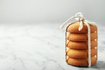 Tasty shortbread cookies on marble table, space for text
