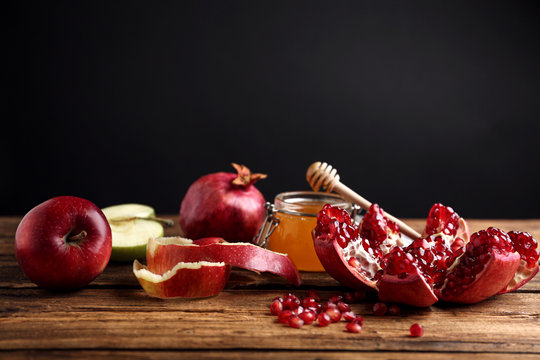 Honey, apples and pomegranate on wooden table. Rosh Hashanah holiday