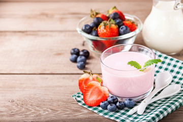 Strawberry yogurt and milk on a table. Selective focus. Copy space