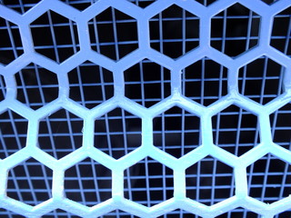 Macro image of a bright blue lattice of hexagonal cells