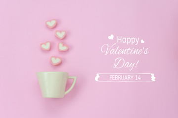 Table top view aerial image of sign valentine's day background concept.Flat lay arrangement white coffee cup with steam heart shape on modern pink paper at home office desk studio & text design.
