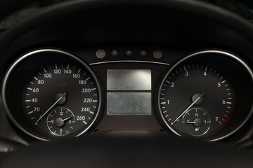 The dashboard of the car with white arrows, speedometer, tachometer and other tools to monitor the...