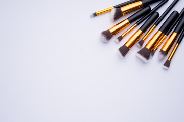 Creative arrangement of cosmetics products on white background.