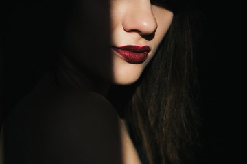 dramatic portrait of a girl with red lipstick on her lips