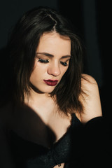 sensual portrait of young sexy sad girl with red lipstick