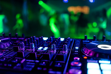 Fototapeta na wymiar DJ mixer controller at a party in a nightclub