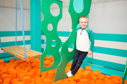 Happy Boy Plays Over Foam Pit