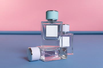set of perfume bottle with a blank label for mine space on a pink, blue stand in the studio....
