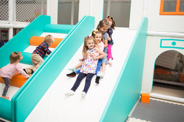 Little girls from chain to go down slide - Powered by Adobe