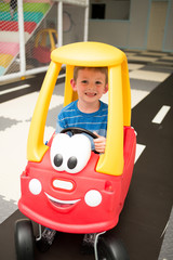 Little Boy Rides in Toy Car