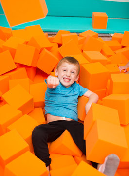 Boy Playing In Foam Pit