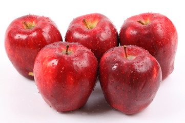 Red apple with water drops isolated on white background.