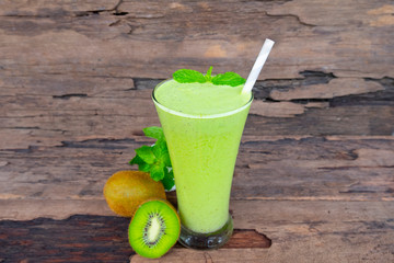 Kiwi yogurt fruit juice smoothie green colorful fruit juice milkshake blend beverage healthy high protein the taste yummy In glass drink episode morning on wood background.