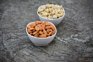 Almonds and Cashews in white bowls 