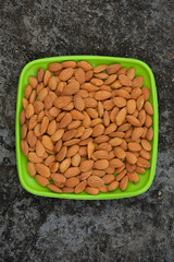 Almonds on a plate. Almonds are healthiest nuts and one of the best brain foods.