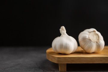 Garlic on the black table. Black background.