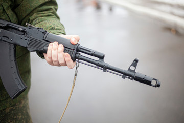 The barrel of an assault rifle. The weapon in the hands. Firearms in combat condition. Kalashnikov...
