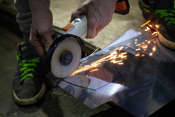 Metal cutting. Grinding steel. Work as a grinder. Sparks from friction. Men's work. Creating a...