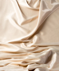 Abstract white wavy textile silk background with milky, creamy, champagne color