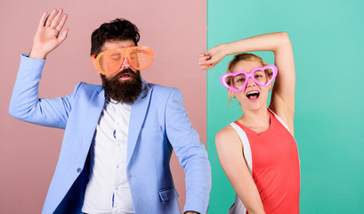 Relax and have fun. Corporate culture. Celebrating holiday. Bearded man pretty woman party goggles celebrating. Couple having fun. Office party. Celebrating success. Dancing together. Good mood