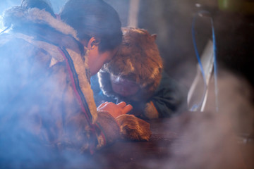 The extreme north, Yamal, the pasture of Nenets people, the dwelling of the peoples of the north, the yurt, artistic toning, big family drinks tea in a yurt, © evgenii