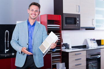 Smiling salesman of furniture accessories store