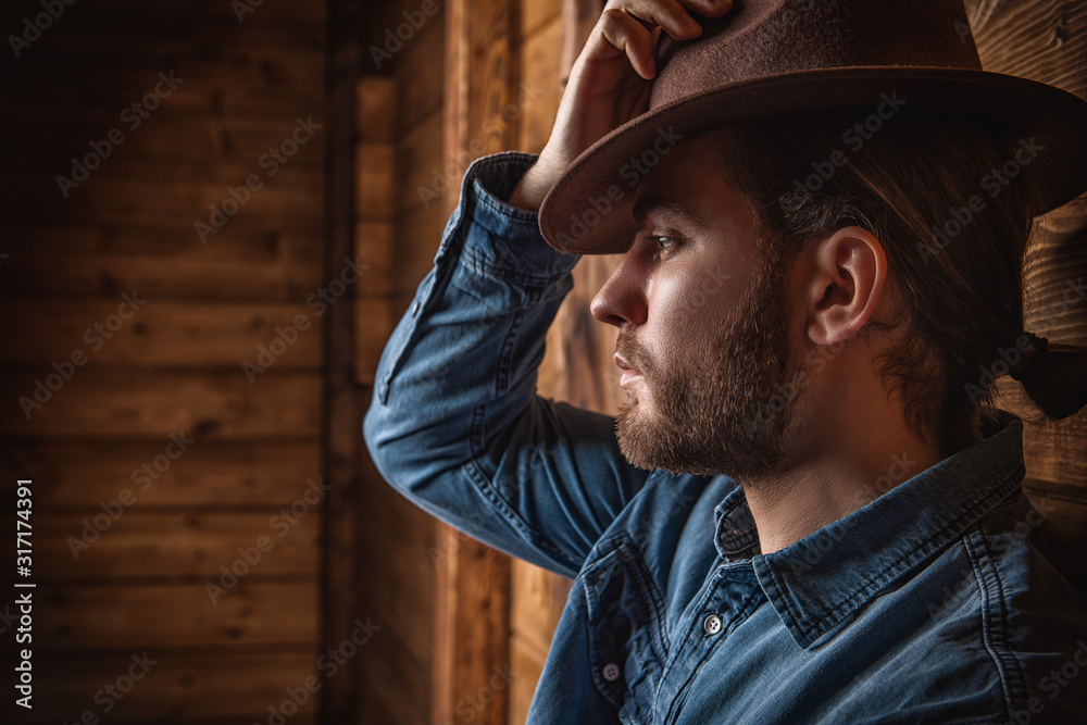 Wall mural goodlooking man in hat