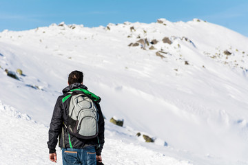 Fototapeta na wymiar Man in the High Snowy Mountain .Winter Vacation Concept 