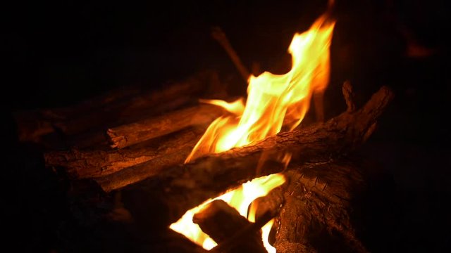 Slow motion camp fire burning at night.