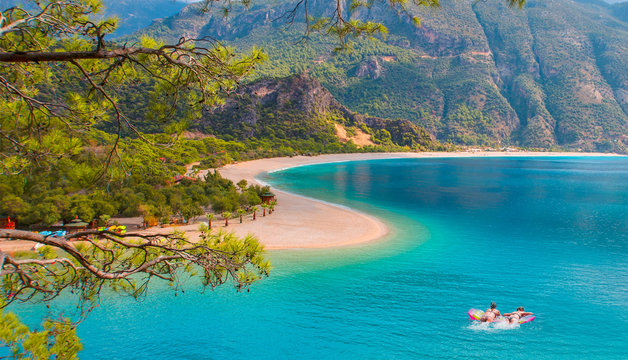 Girls in bikini lying on air bed - Oludeniz Beach And Blue Lagoon, Oludeniz beach is best beaches in Turkey - Fethiye, Turkey © muratart