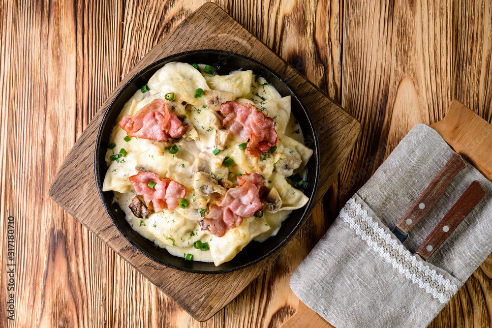 Sticker homemade dumplings with bacon in a pan