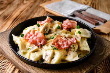homemade dumplings with bacon in a pan
